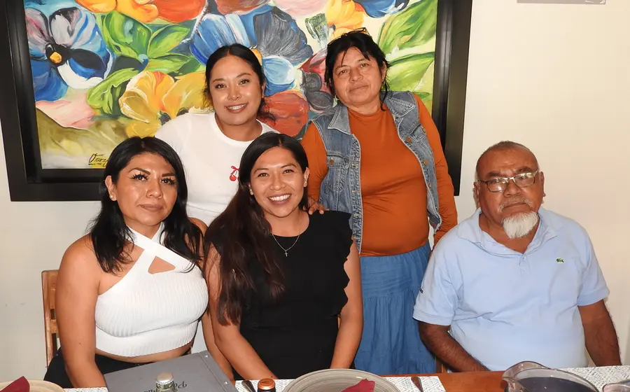 La familia Quiroz Cabrera posa sonriente para una foto durante la celebración de un momento muy especial, compartiendo su felicidad.