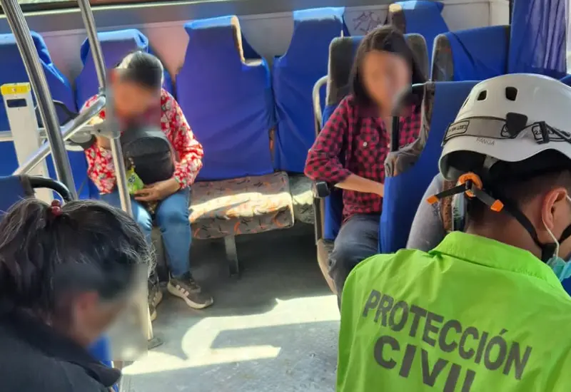 Paramédicos brindan primeros auxilios a tres pasajeros que resultaron heridos en el lugar de un accidente tras un choque de autobús.